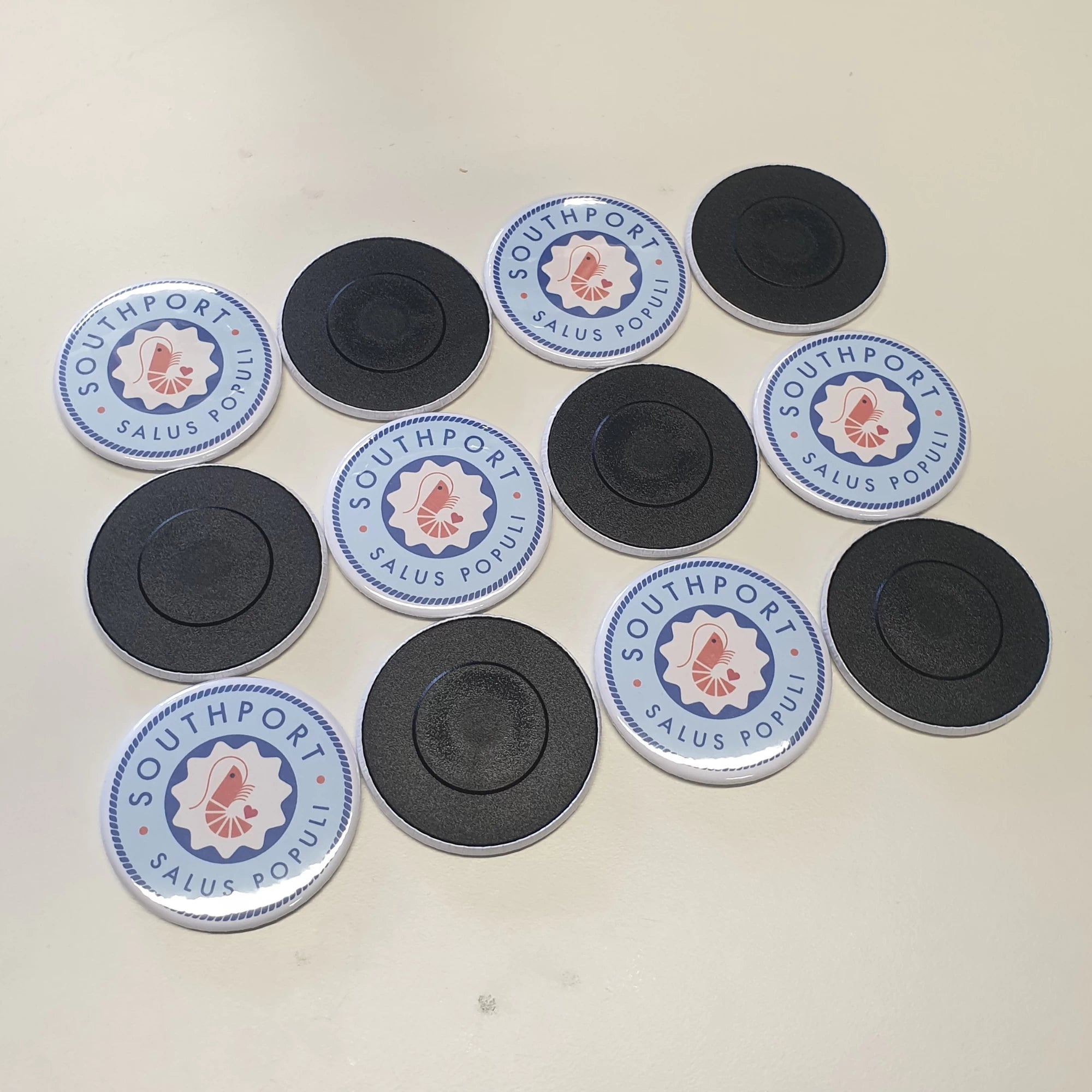 Personalised magnets with a business name on them. Some flipped over.