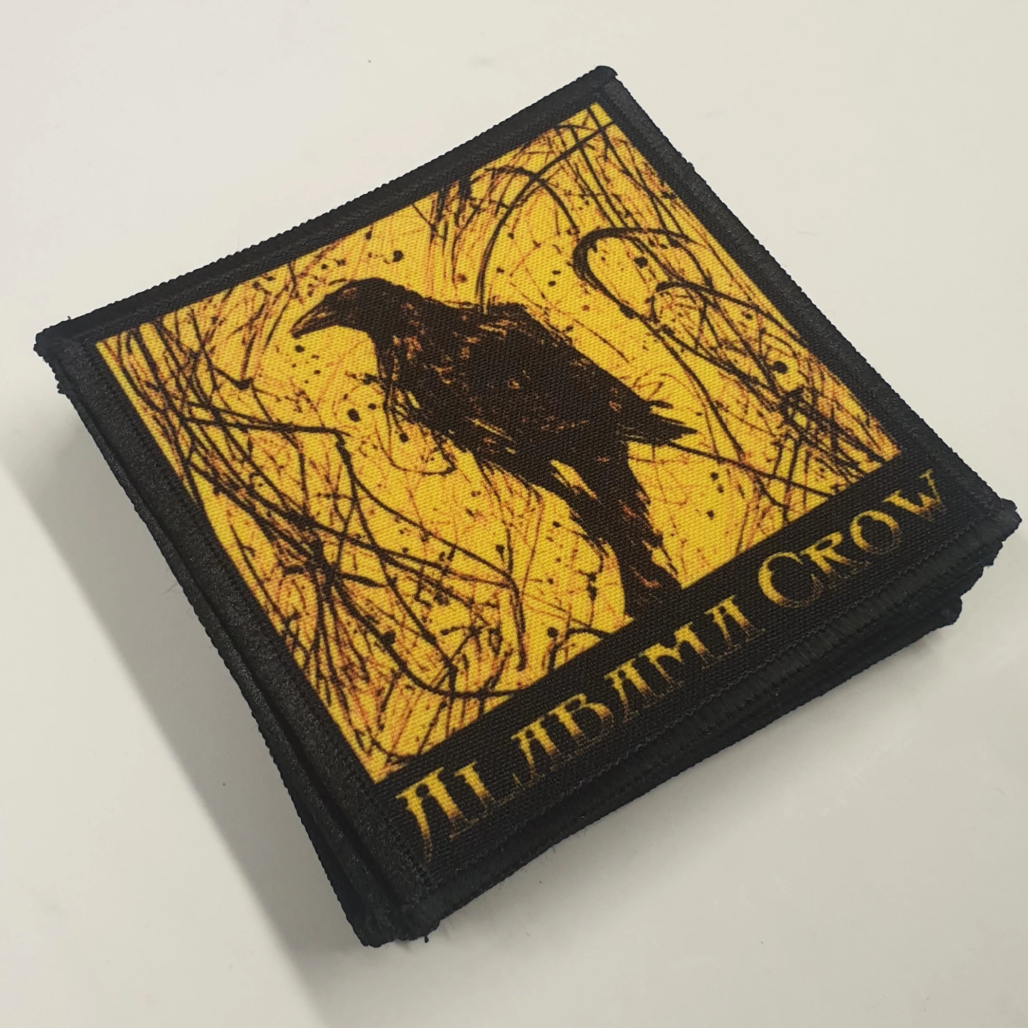 Square patch with Alabama Crow logo design.