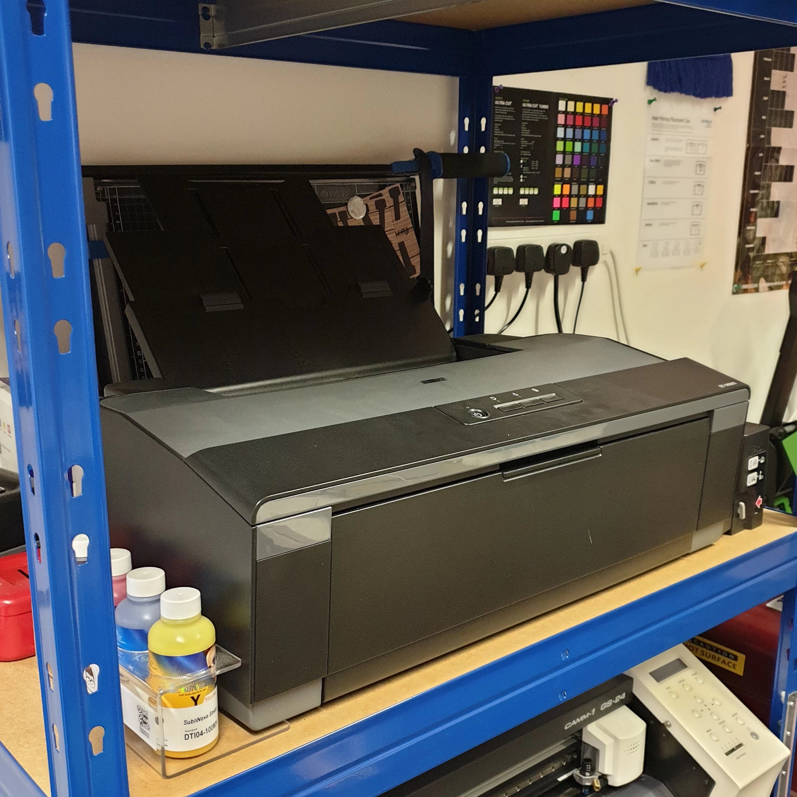 A3 Epson sublimation printer for making custom-printed merchandise such as patches, mugs, beer steins, trucker caps, vinyl slipmats, and bar blades.