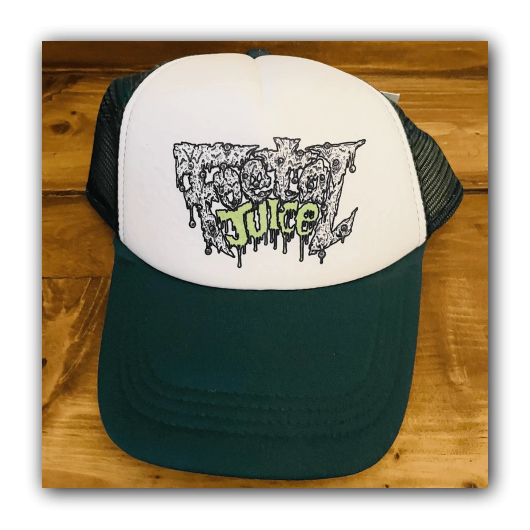 Green Foetal Juice trucker cap with logo print on the front.