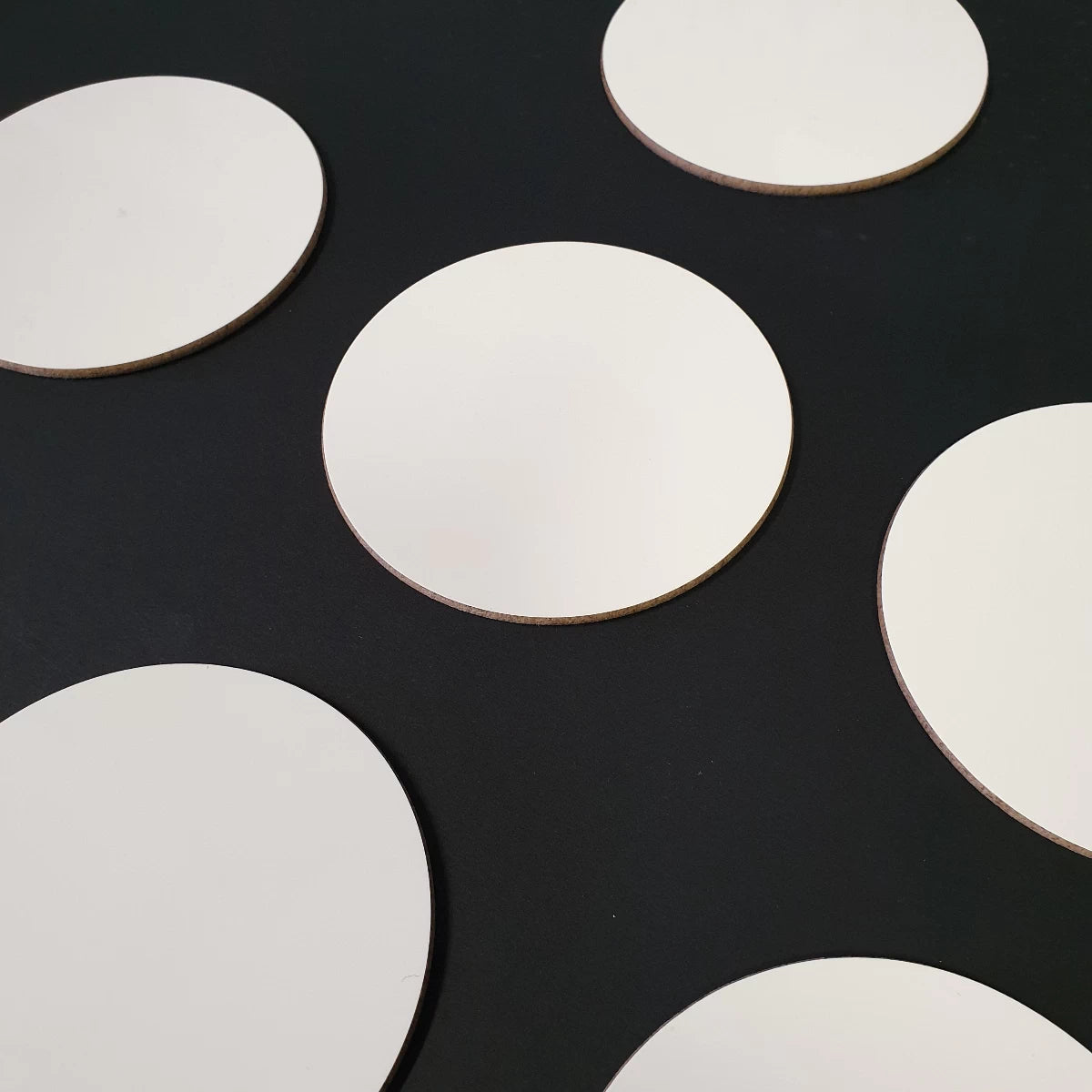 Circular 9cm custom coasters ready for printing band logos onto.