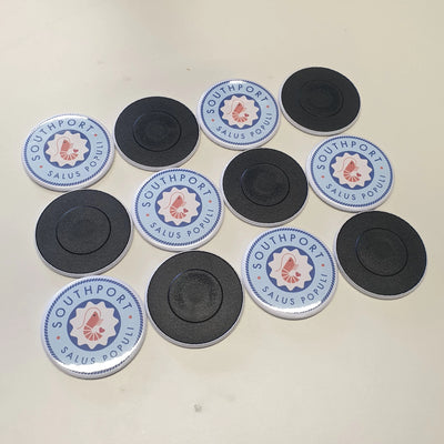 Personalised magnets with a business name on them. Some flipped over.