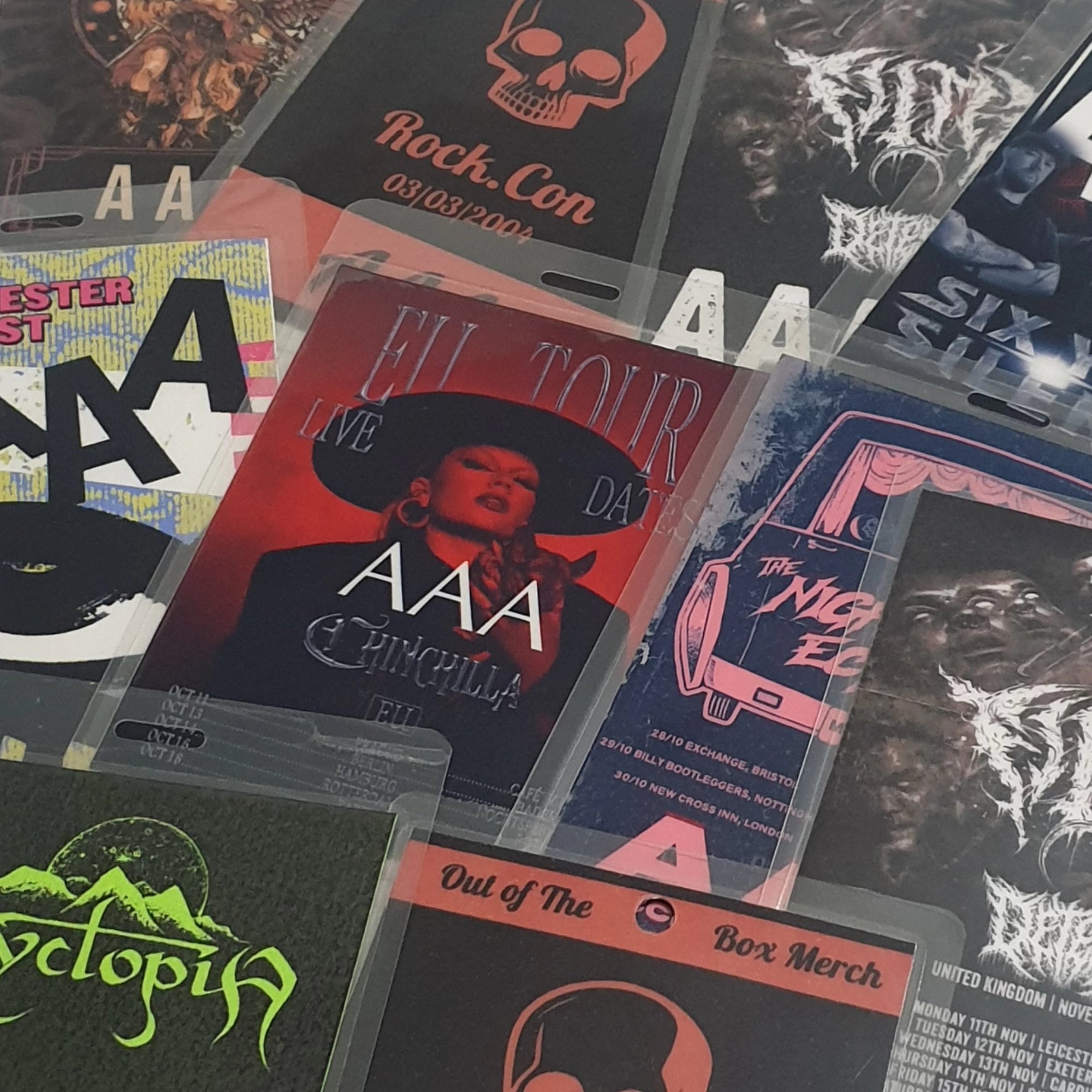 Collection of AAA & backstage passes with various designs and text.
