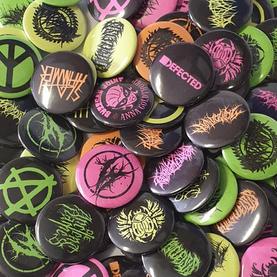 Collection of colorful buttons with various designs and text.