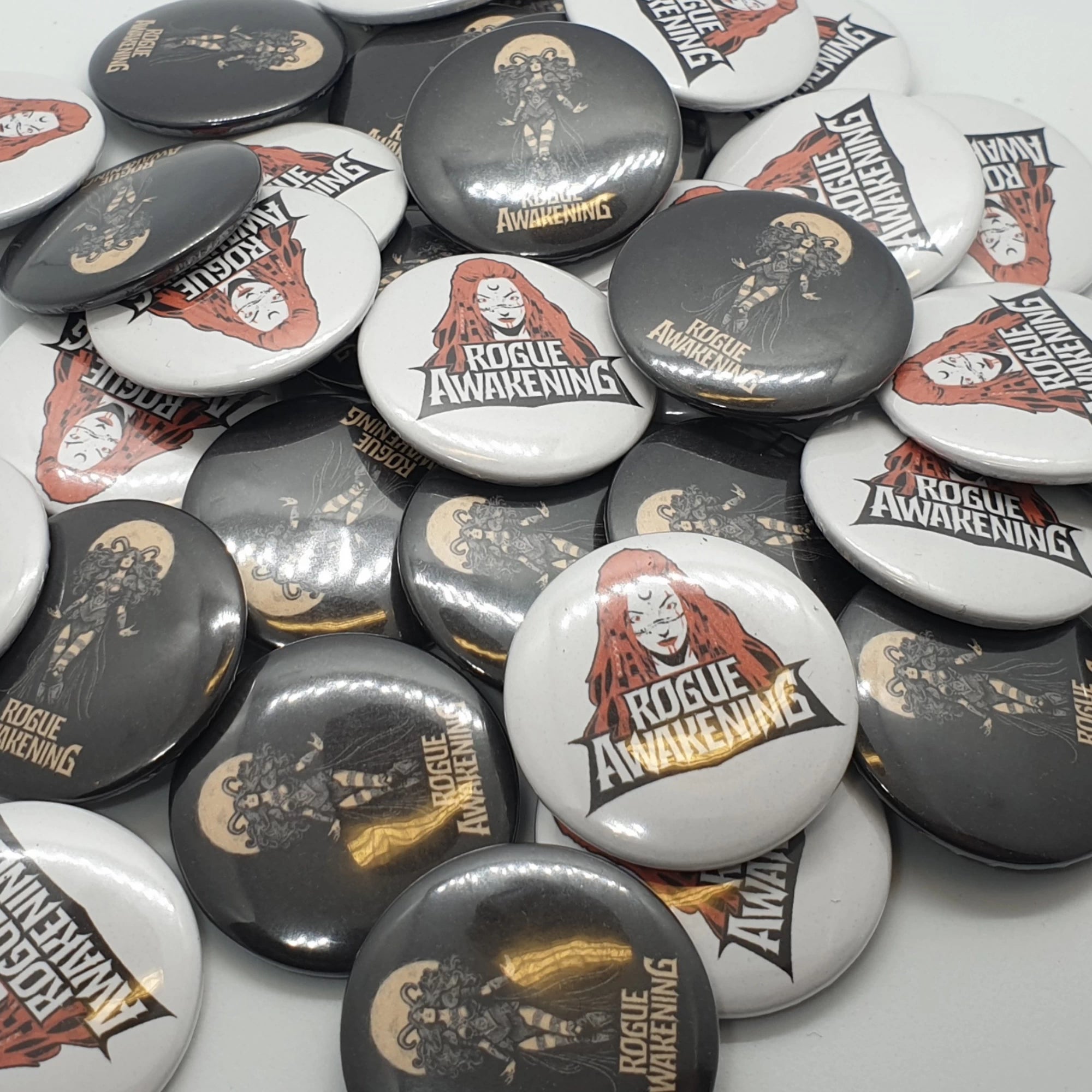 Collection of 'Rogue Awakening' badges with various designs on a white background