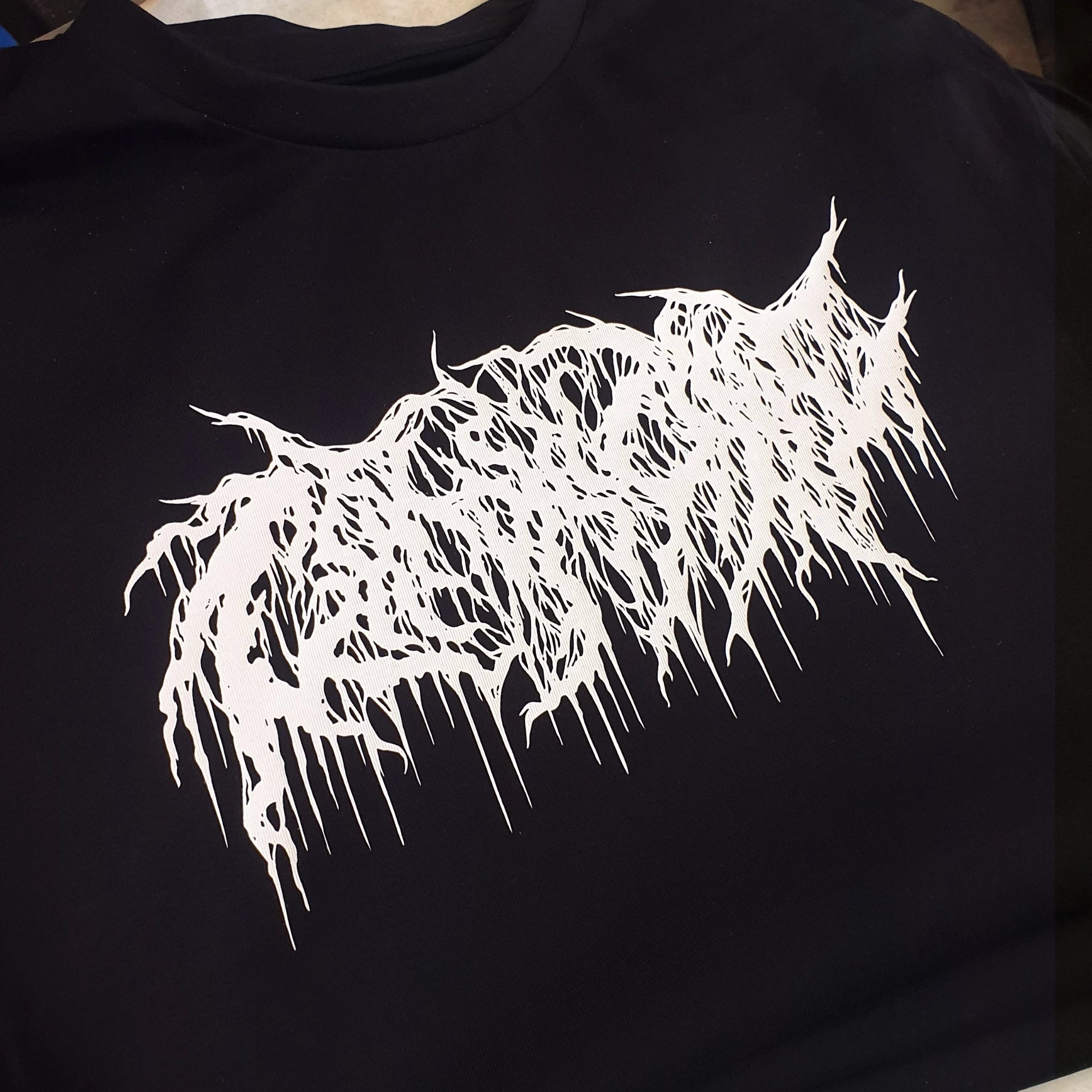 White logo on a black t-shirt