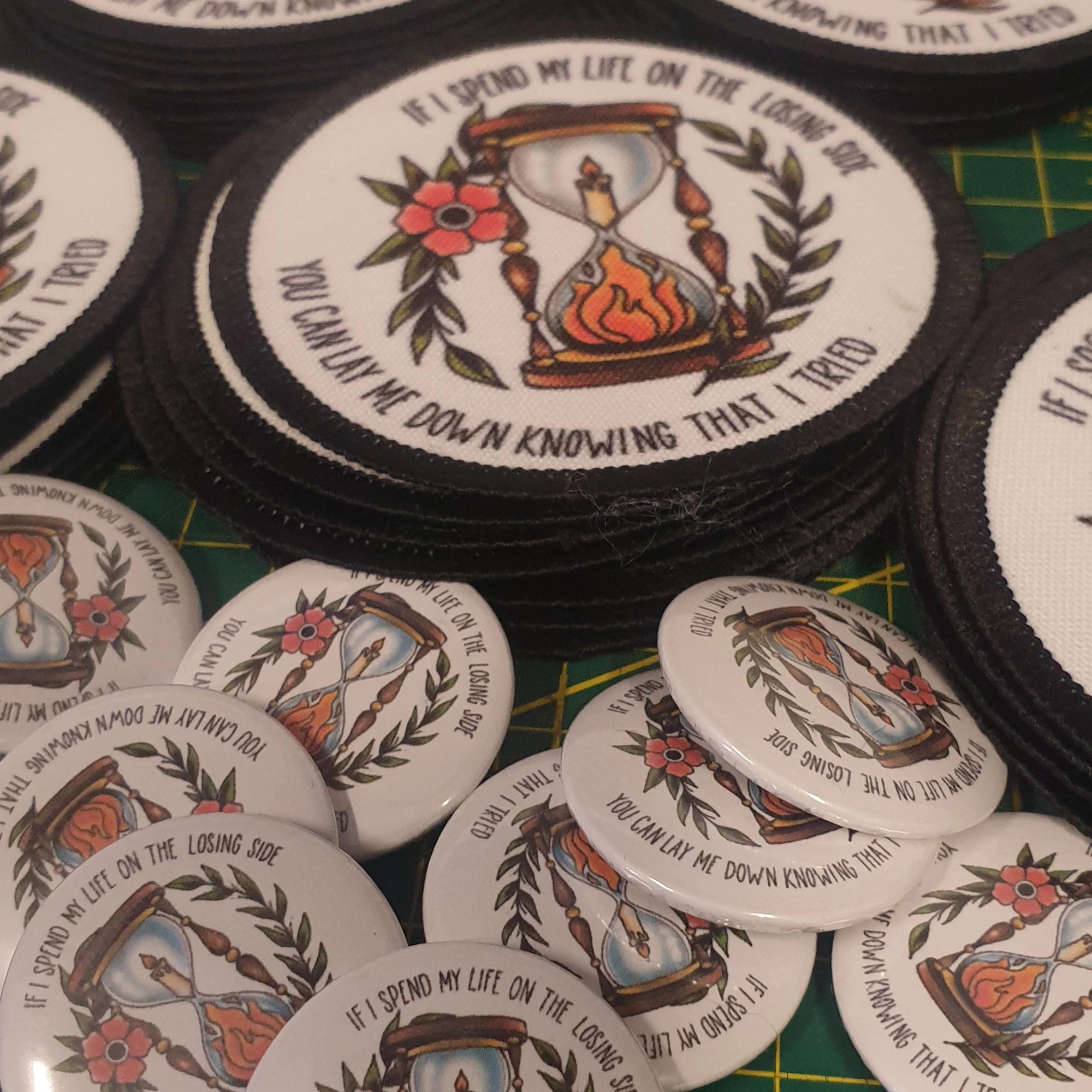 Circular patches with an hourglass design and text.