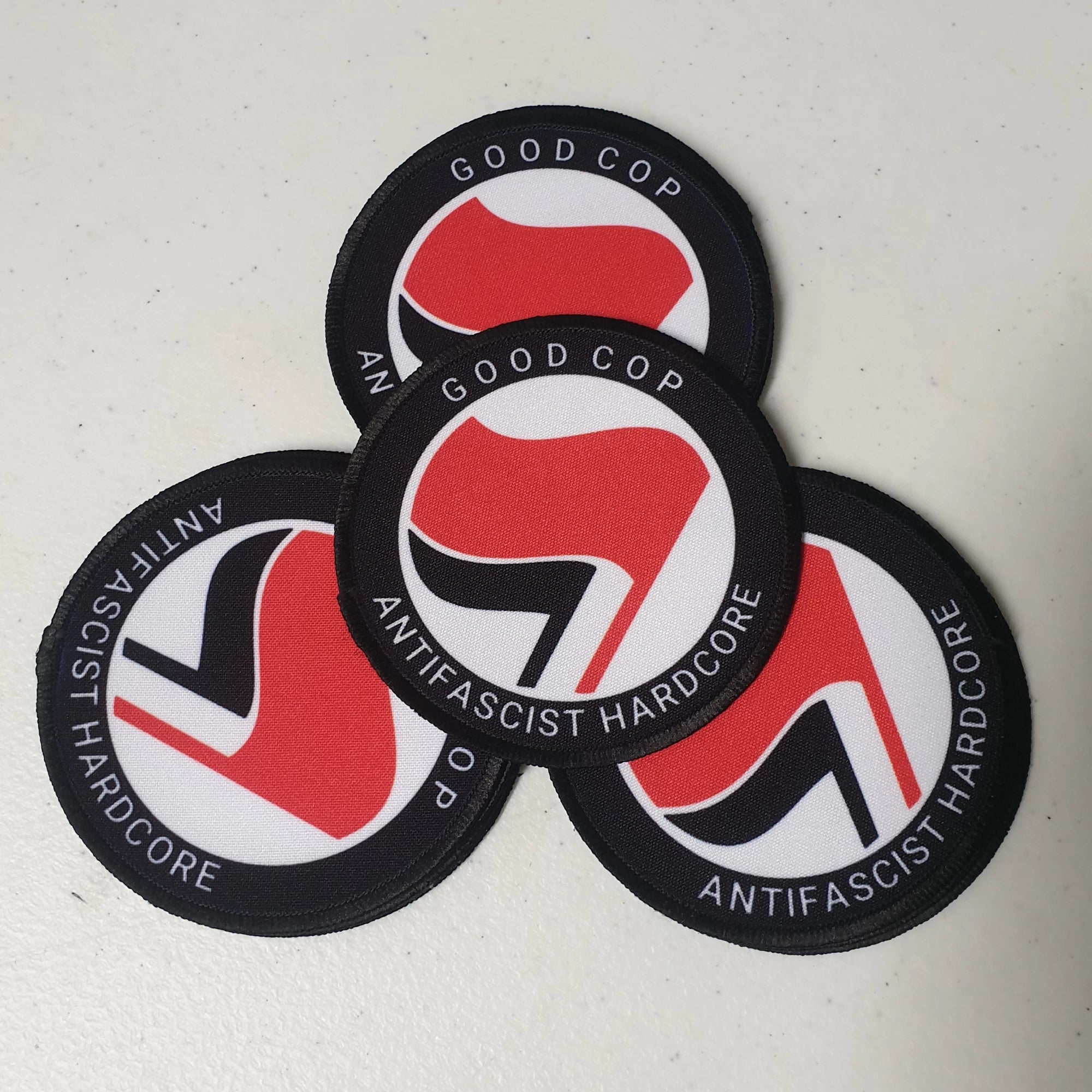 Three antifascist hardcore patches with a red and black design on a white background.