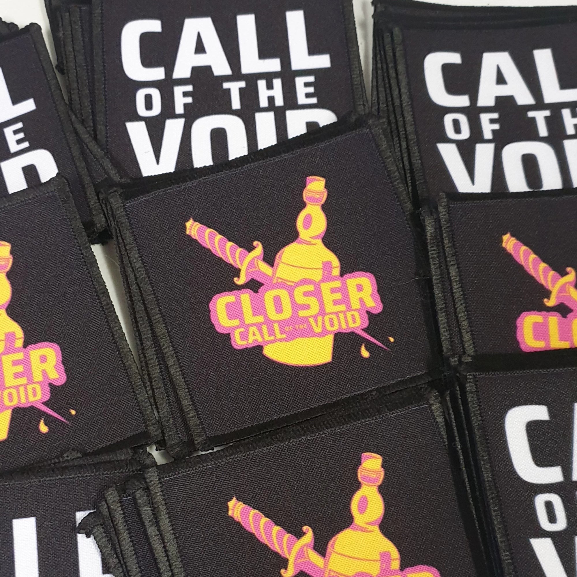 Collection of 'Call of the Void' patches with a central patch featuring a bottle and text.
