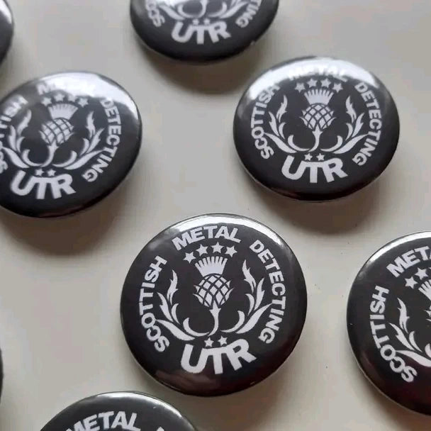 Close up of Scottish Metal Detecting badges.