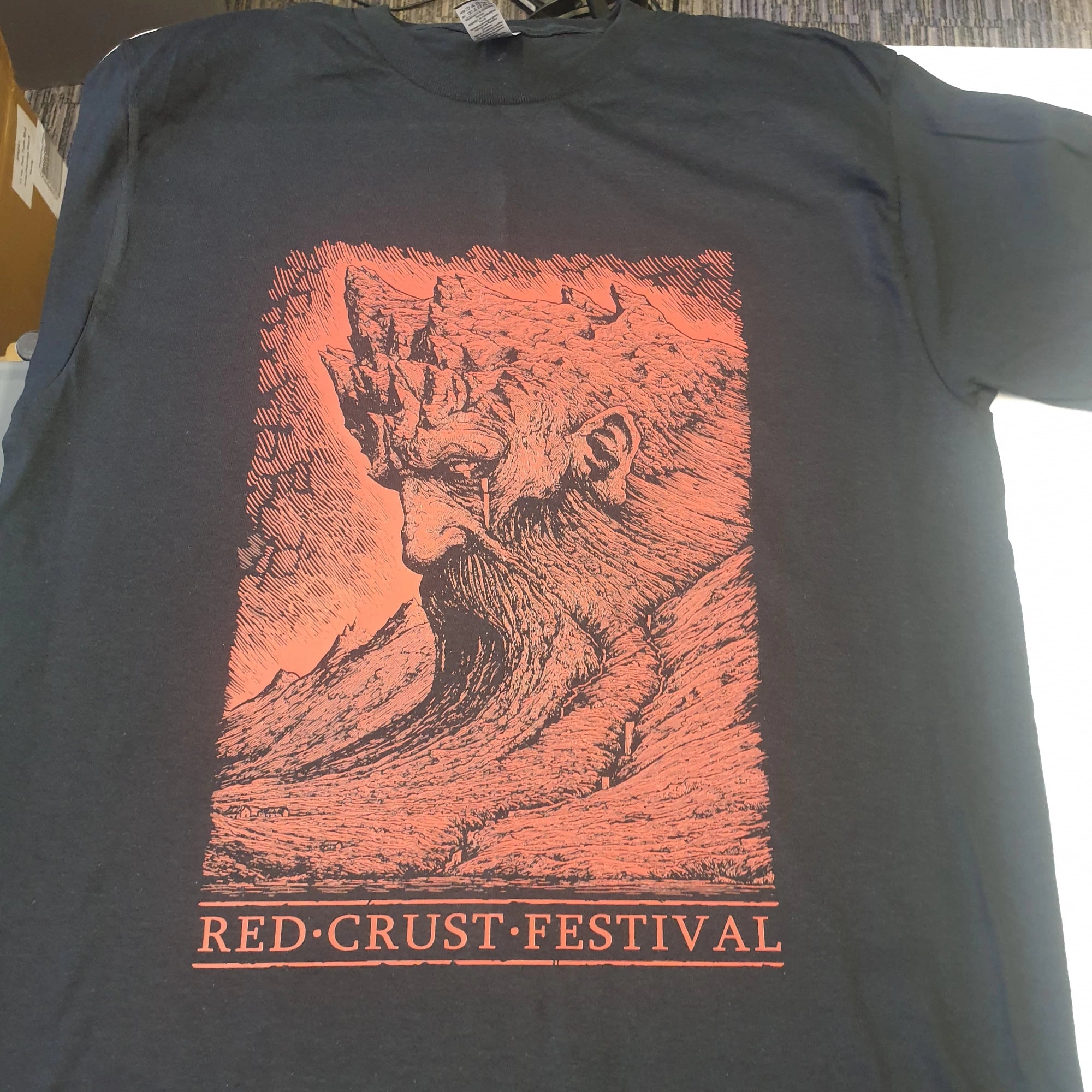 Black t-shirt with red graphic and 'Red Crust Festival' text on a white background